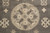 Detail of sand beige medallion ringed by ivory cross rosettes in soft Chobi wool pile