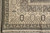 Ivory corner border with shield cartouches, T motif outer band and hand-tied ivory fringe