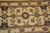 Close-up of diamond rosettes, sage palmettes and charcoal star flowers on soft beige wool field