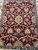 Field detail of 8 by 10 Agra rug showing repeating palmettes, buds and blue blossoms