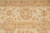 Border and guard stripe detail showing palmette, meandering vine and muted gold tones in wool