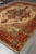 8'8" x 12' Serapi area rug angled on grey floor, ideal large living room size