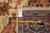 Rug back with tape measure and tag reading genuine hand woven Oriental rug F-4585