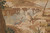 Detail of two wading birds beside a stream under a wooden trestle bridge in browns