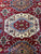 Ivory and light blue central medallion with 8 point stars, rosettes and red hexagon core