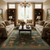 Green modern rug anchoring a beige living room with twin sofas, coffee table and bookcases