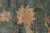Detail of a large gold and rose lotus blossom on variegated teal green wool pile