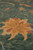 Thick wool pile seen from the side, gold 8 petal rosette with dusty rose centers