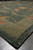 Perspective view of the plain border and corner vine scroll on this 9x12 transitional rug
