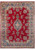 Full view of 9x12 Persian Kerman rug with red field, blue medallion and ivory floral border