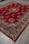 Corner perspective of this 9 x 12'5 Kerman rug with ivory fringe and multicolor border