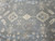 Field detail with ivory stepped medallions, small rosettes and vine tracery on gray ground