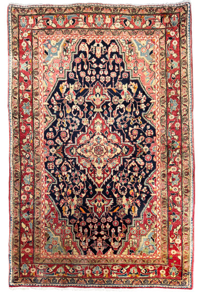 A full view of a 4'3" x 6'5" Vintage Persian Sarough Rug with intricate floral designs and a deep navy blue central field surrounded by borders of cream, crimson, and sage.