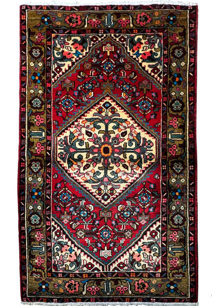 Intricately patterned 3'3 x 5'2 Persian Hamedan rug with a dominant red field and a central floral medallion."