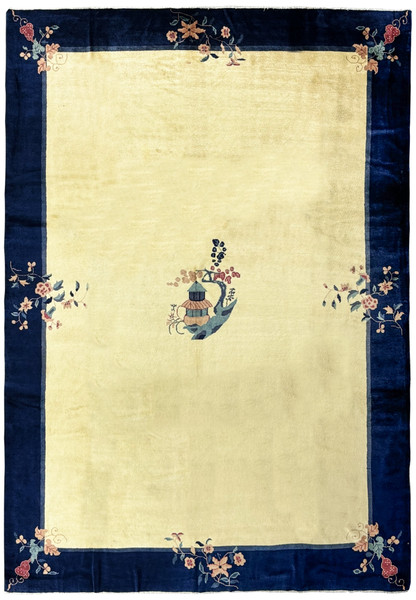 A 10 x 14 vintage Art Deco rug with a navy blue border and a central beige field displaying a stylized vase motif and corner floral designs, in pristine condition
