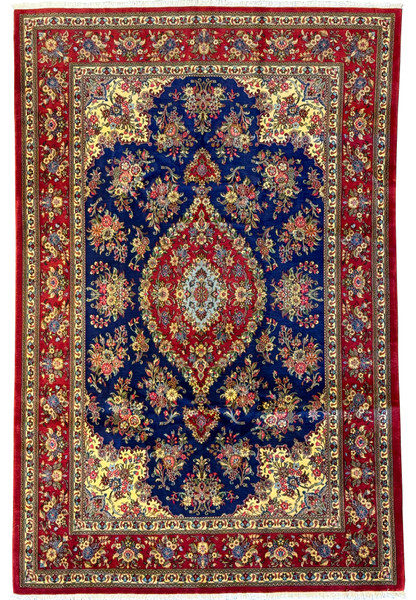 Full view of a 6'5" x 9'9" Persian Qum Kork and Silk Rug showcasing a deep navy blue field with a vibrant central medallion in red and cream, surrounded by intricate floral and vine motifs in red, cream, gold, and green accents