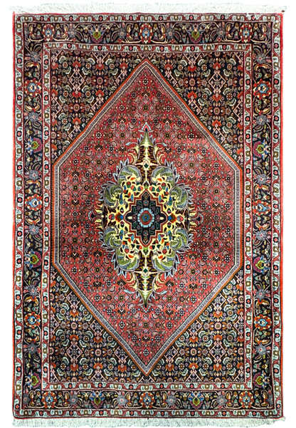 Image of the full Persian Bidjar rug with a unique medallion design: This image shows the complete 3'9" x 5'8" Persian Bidjar rug. The central medallion is surrounded by intricate floral and geometric patterns in vibrant colors, set against a deep red field, framed by a detailed border.