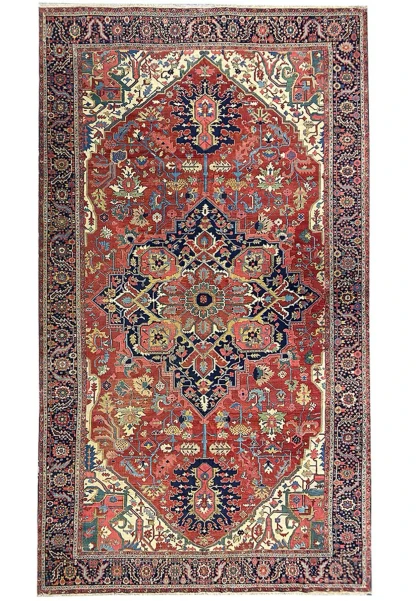 Full view of 12x21 antique Persian Serapi Heriz rug with bold medallion, ivory spandrels, navy border