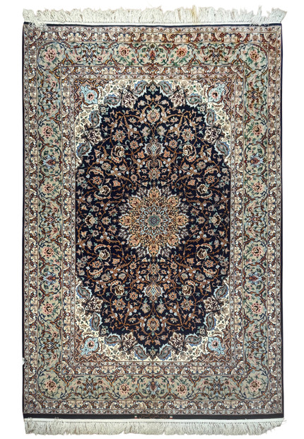 Full view of 4'11 x 7'7 signed Persian Isfahan rug with navy field and intricate floral medallion design in wool and silk