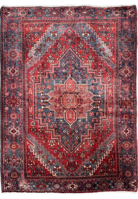 Full view of a vintage Persian Bijar rug showcasing intricate geometric patterns with a dominant central medallion, set against a deep red and navy blue color scheme