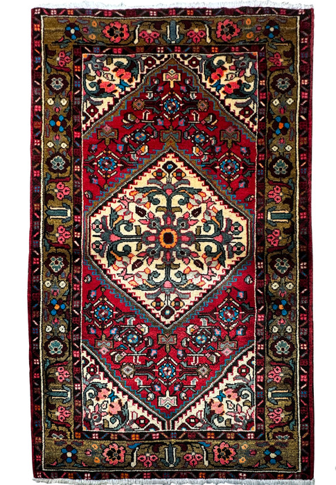Intricately patterned 3'3 x 5'2 Persian Hamedan rug with a dominant red field and a central floral medallion."