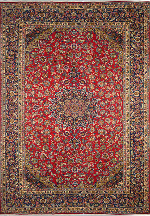 A top-down view of a 9'8 x 13'1 Persian Isfahan rug, highlighting its lush red field and dense, elaborate central medallion, surrounded by layers of detailed floral motifs and an ornate primary border with intricate guard borders