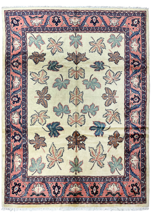 Full view of a hand knotted Persian Farahan rug with ivory field, allover leaf motifs, and salmon pink botanical border