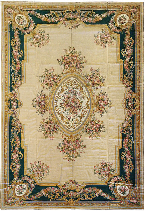 Full view of an 11'4 x 18 French Aubusson rug with beige field, emerald green floral border, oval medallion, and classical rose garland design