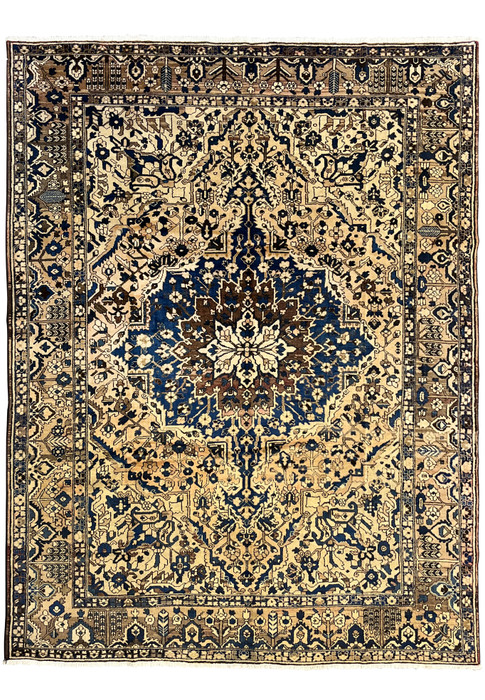 11 x 13'3 vintage geometric Persian Heriz rug in muted navy and ivory featuring bold central medallion and large ivory field with tribal border