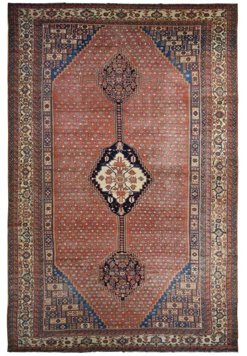 Palace size antique Persian Bakshaish rug circa 1900 with anchored medallion on dark coral field