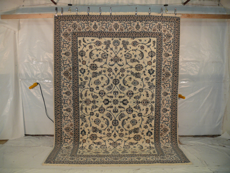 Angled view showing alternating light blue and turquoise details on beige background