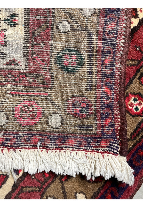 Backside of an antique Persian Hamedan tribal rug displaying tight hand-knotted structure, clear pattern visibility, and traditional village craftsmanship