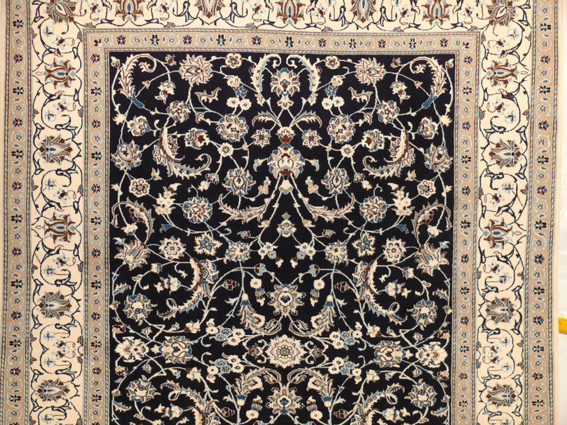 Close-up detail showing the fine silk and wool weave of the Persian Nain rug