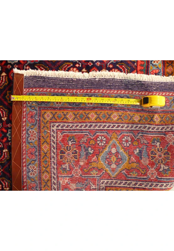 The back of a 10 x 13 Persian Mahal All Over design rug with a ruler showing the dense quality of the weave