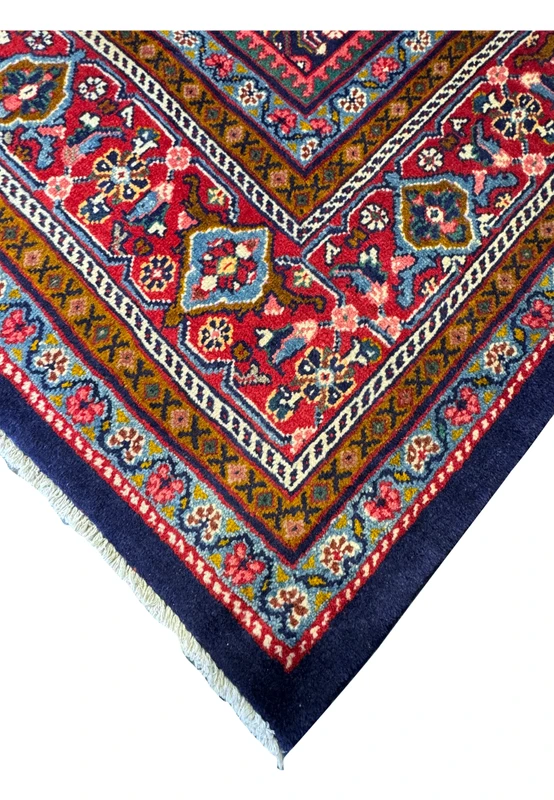 Close-up of the vibrant red and gold border design on the Persian Mahal Rug.