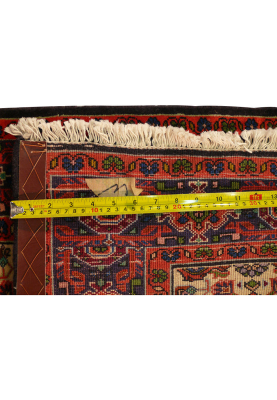 Zoomed image of the backside of the 3x9 Bijar All Over Runner Rug measuring knot density with a ruler.