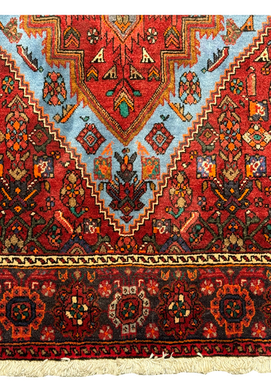 Corner detail of a Persian Gholtogh Rug showcasing the traditional border design with floral and geometric motifs