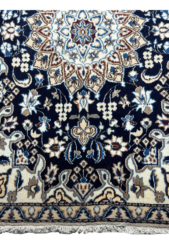 Witness artisanal mastery! This image zooms in on the meticulous craftsmanship and attention to detail evident in our Persian Nain Rug.