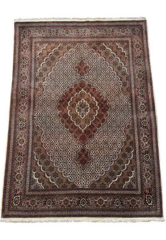 Full view of a 5x7 Persian Tabriz Mahi rug, illustrating the symmetry and balanced design of the central medallion, corner brackets, and comprehensive border pattern