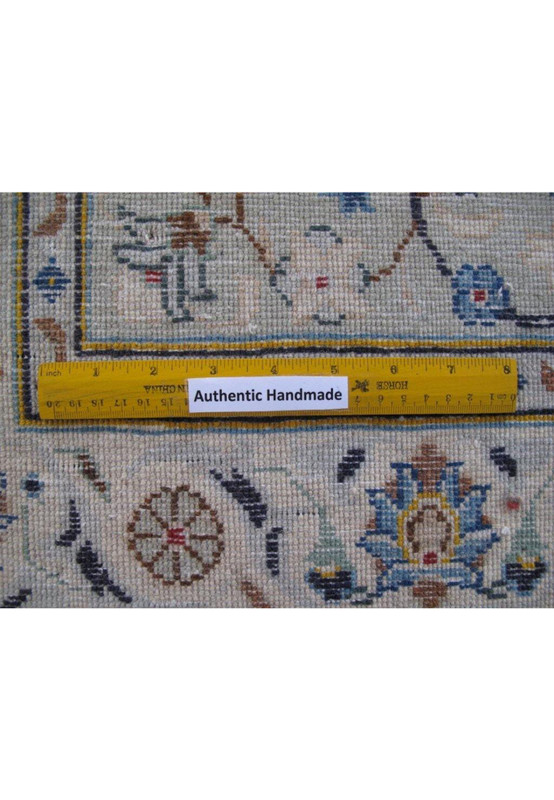Authentic Handmade label on a 11 x 18 Persian Kashan rug, with a ruler for scale and detail clarity.