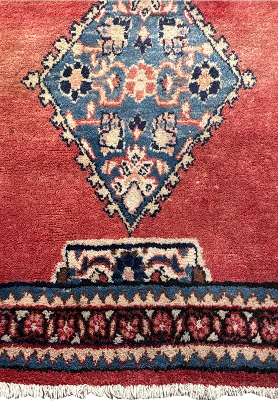 The dense weave and fringe of a Persian Hamedan runner rug, highlighting its handcrafted quality