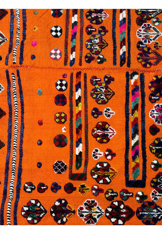 Close-up of traditional motifs on a Persian Qashqai Horse Cover Rug with vivid orange background