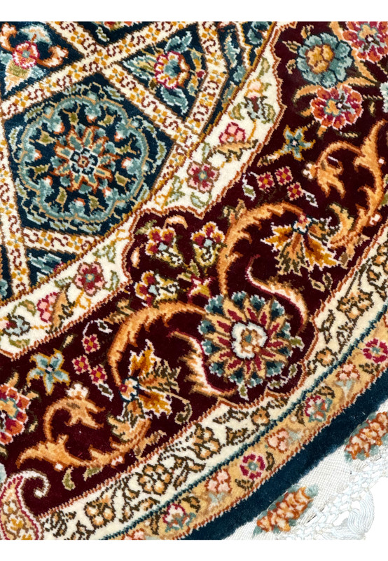 Angled view of the Persian Qum silk rug, emphasizing the depth of the design and luxurious sheen of the silk