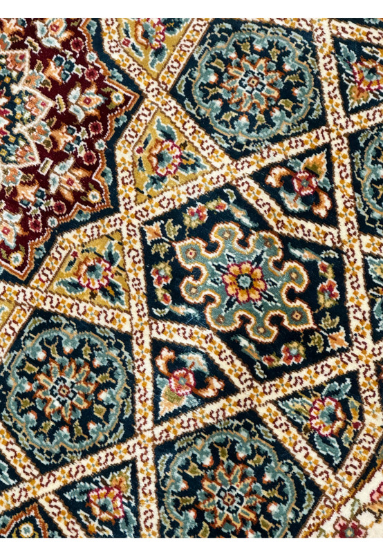 Detailed perspective of the Persian Qum silk rug patterns, with focus on the vibrant medallions and ornate florals.