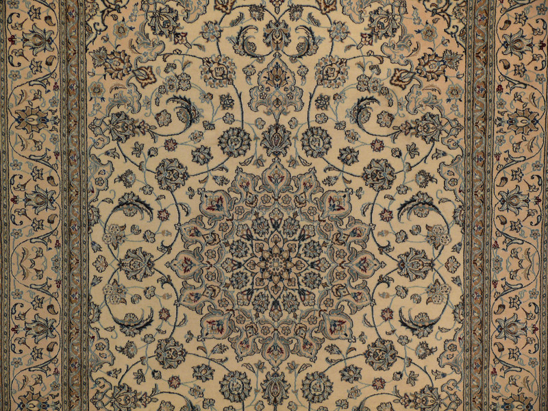 Close-up of central medallion with navy background, wine red blossoms, and ivory outlines