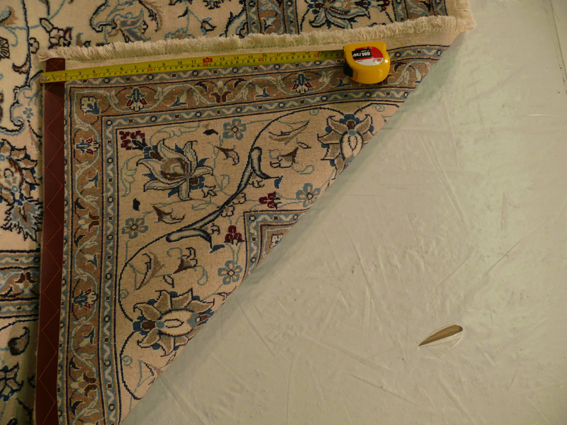 Backside of Persian Nain rug showing cotton foundation and fine hand-knotted weave