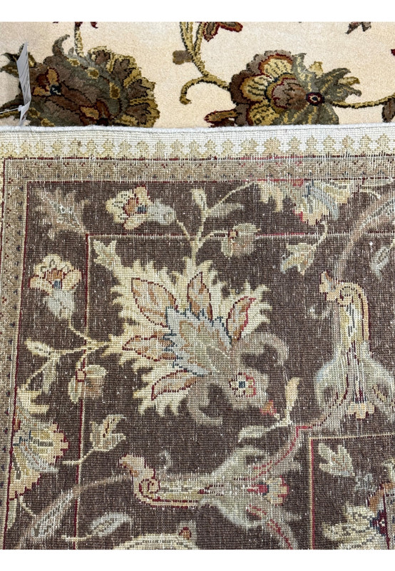 A close-up of the Chobi rug's border and fringe, showcasing the detailed patterns and texture of the rug's edge.
