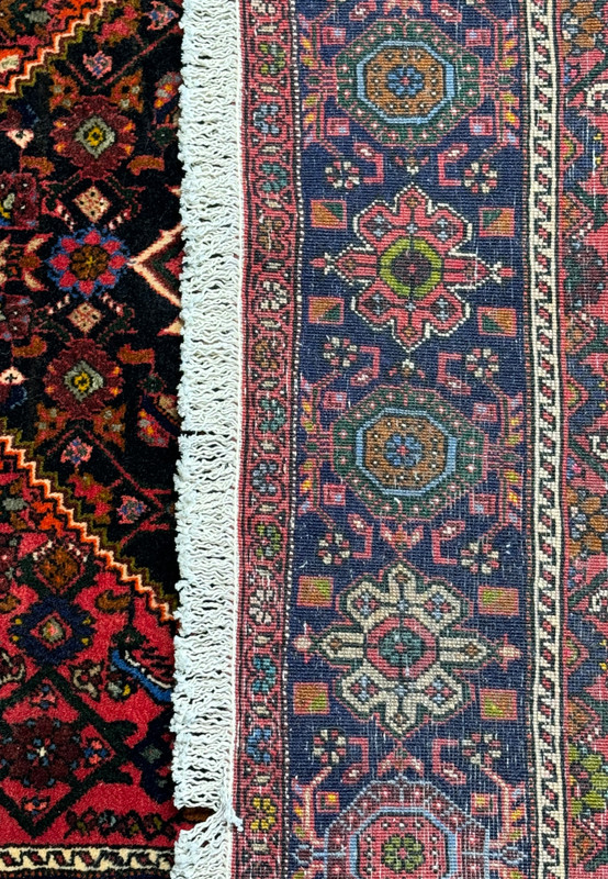 Perspective view of the Persian Gholtogh rug showing the plush texture and the detailed edge finishing with fringes.