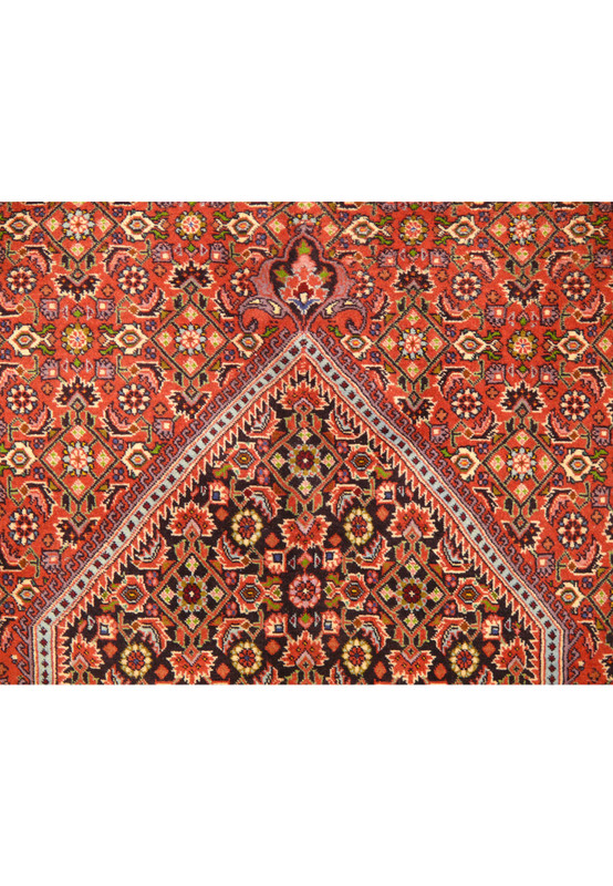 Top section of a Persian Bijar rug, emphasizing the detailed patterns and vibrant color scheme