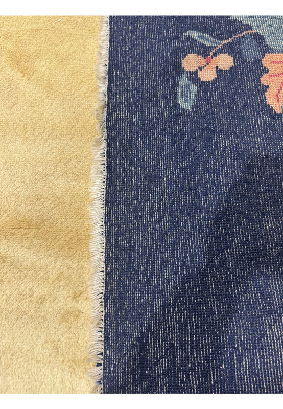 The back of a 10x14 Art deco vintage rug showing the perfect quality and weave of the rug from the 1960s